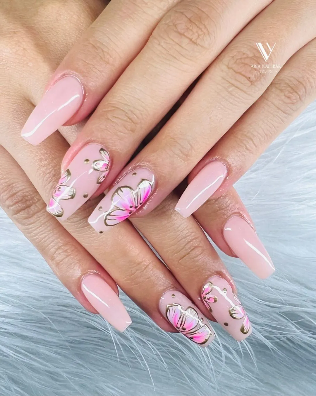 Pale pink coffin nails with hand-painted pink petals outlined in gold.